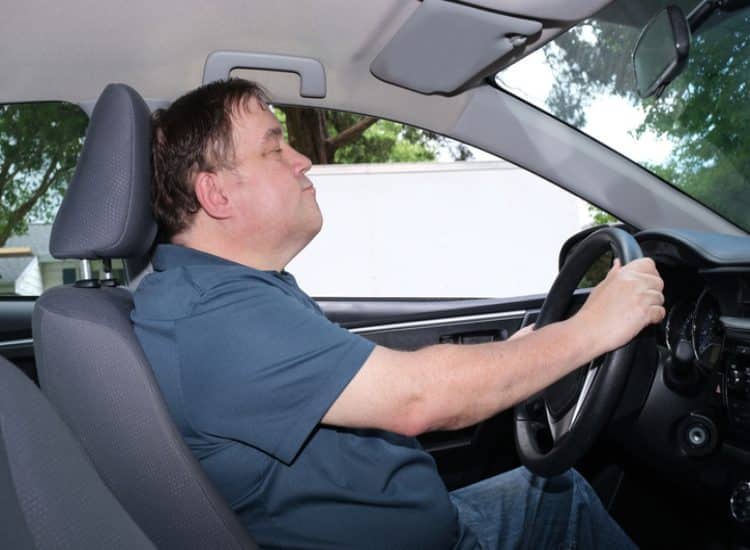 Tired Car Driver Yawning, Showing Risk of Fatigue Accidents in Fort Collins, CO